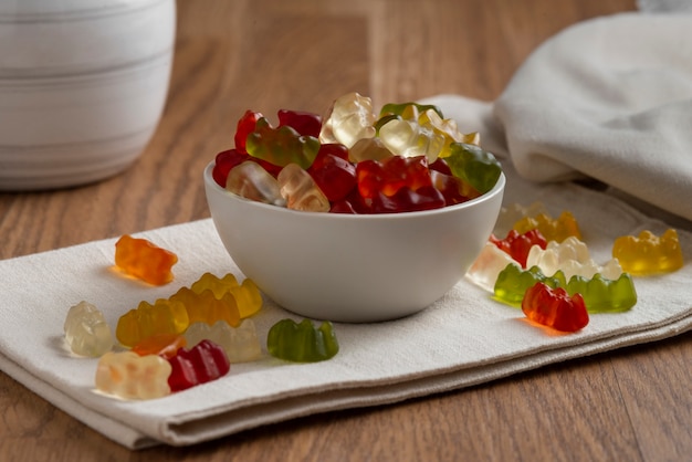 Free Photo view of sweet gummy bears with bowl