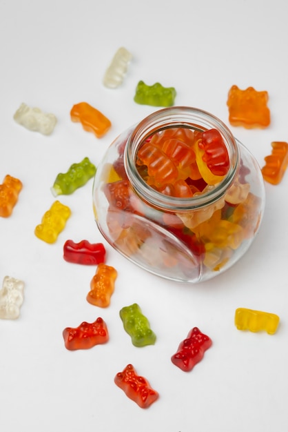 Free photo view of sweet gummy bears with glass jar