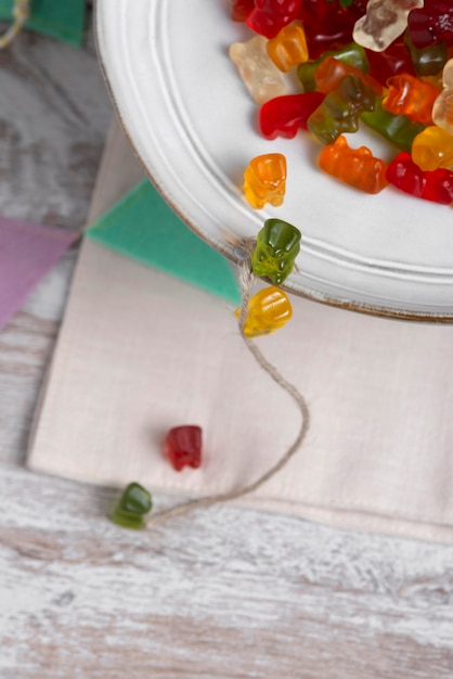 Free photo view of sweet gummy bears with plate