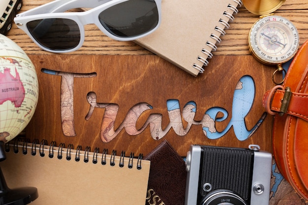 Free photo above view traveling items on wooden background