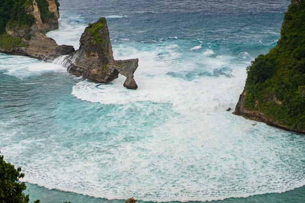 View of tropical beach, sea rocks and turquoise ocean, blue sky. Atuh beach, Nusa Penida island, Indonesia. Travel concept. Indonesia