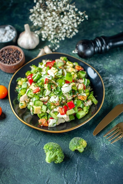 above view vegetable salad consists of cucumber cheese and tomatoes on dark-blue background