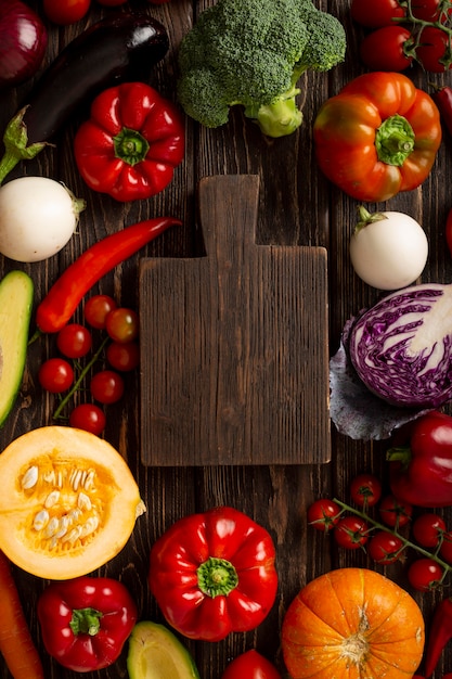 Free Photo above view vegetables and wooden board