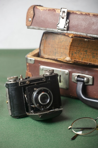 Free photo view of vintage camera with briefcase and books