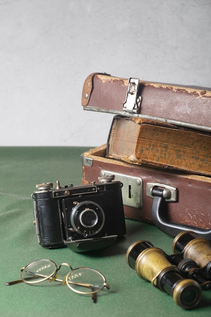 Free photo view of vintage camera with briefcase and books