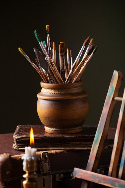 View of vintage paint brushes and easel