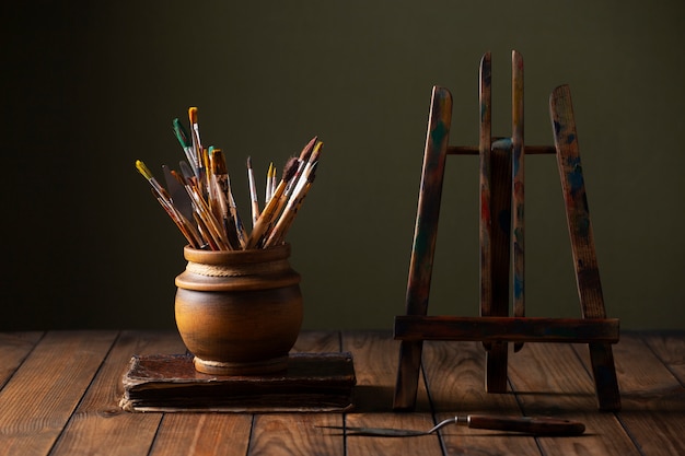 Free photo view of vintage paint brushes and easel