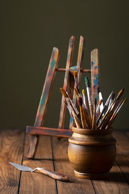 Free photo view of vintage paint brushes and easel