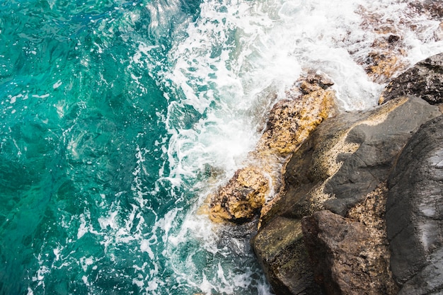 Above view waves at rocky shore