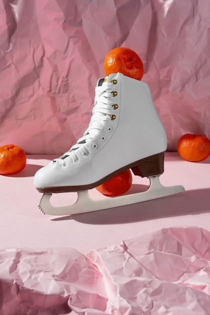 Free photo view of white ice skates with tangerines