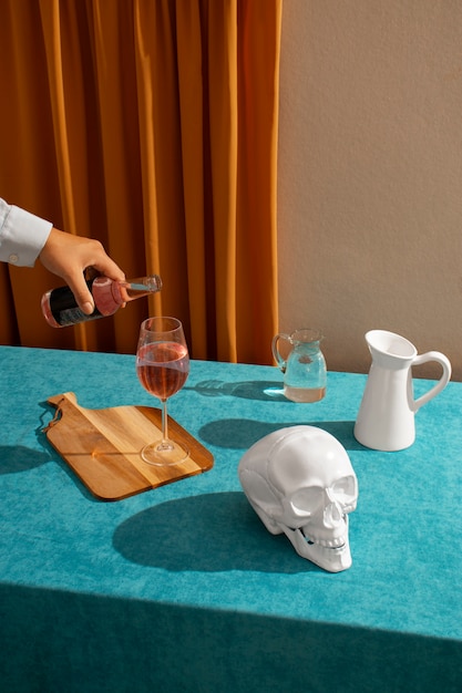 Free photo view of white skull with alcoholic drink