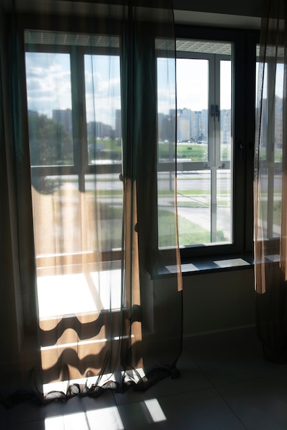 View of window with textile curtains and shadows