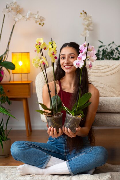 View of woman decorating her home with orchid flower