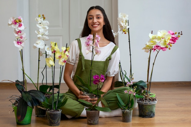 View of woman decorating her home with orchid flower