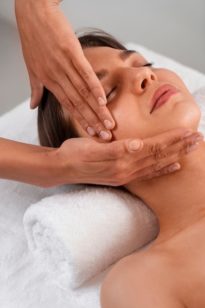 Free photo view of woman getting a facial yoga massage to stay young