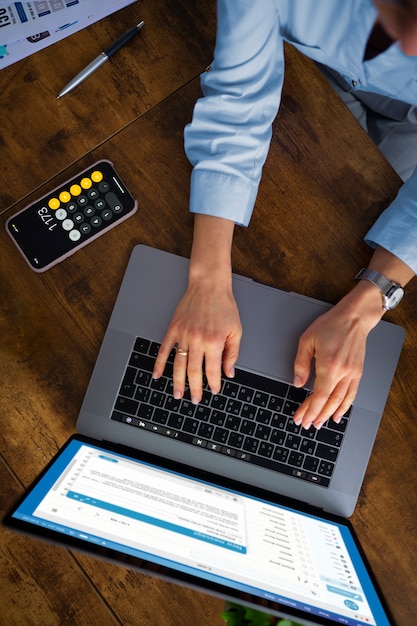 Free Photo above view woman typing on laptop