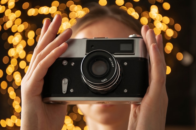 Free photo view of woman using professional camera