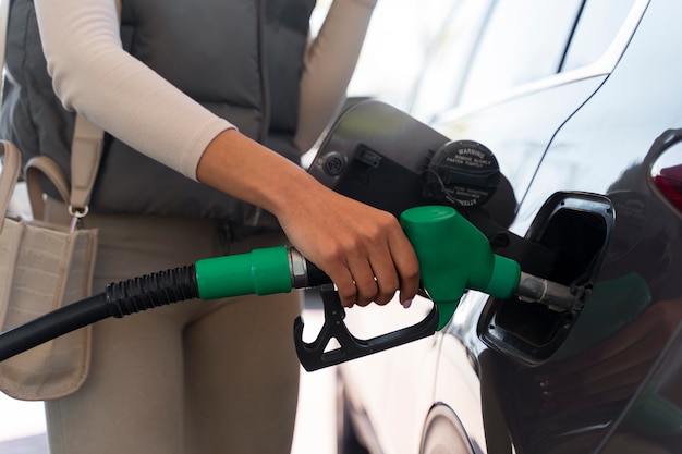 Free photo view of woman with car at the gas station