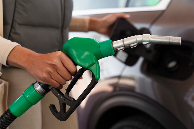 View of woman with car at the gas station