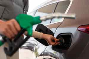 Free photo view of woman with car at the gas station