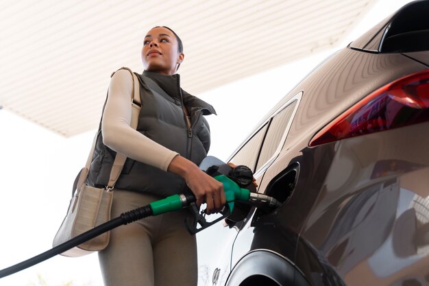 View of woman with car at the gas station