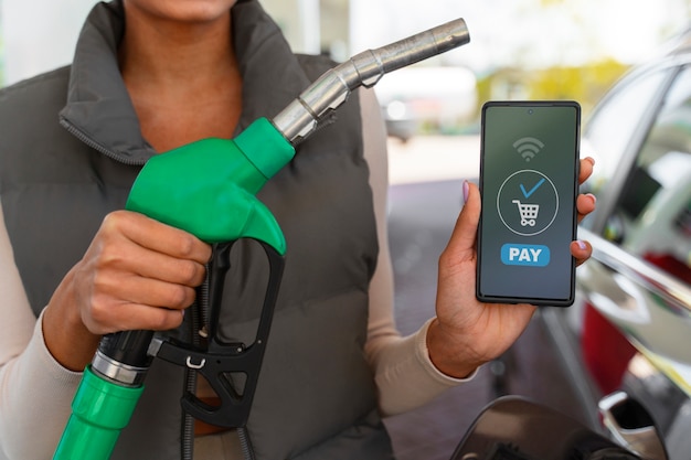 Free photo view of woman with car at the gas station