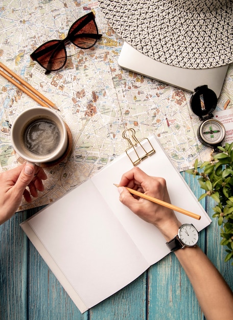 View of world travel map and hand writing in notebook