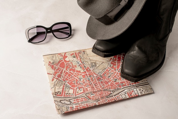 Free photo view of world travel map and shoes with glasses