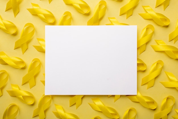 Free photo view of yellow ribbon with paper