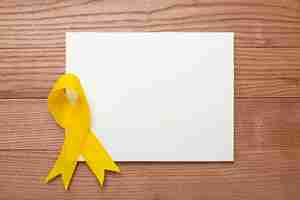 Free photo view of yellow ribbon on wooden background