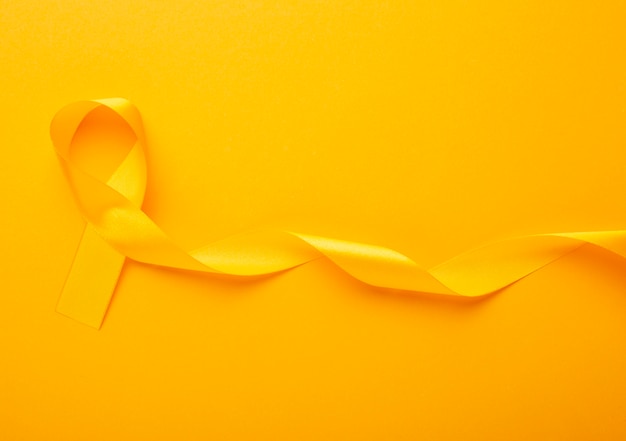 View of yellow ribbon on yellow background