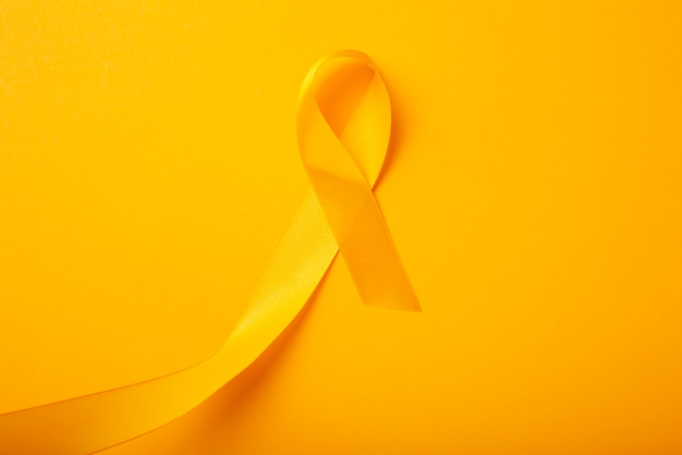 Free photo view of yellow ribbon on yellow background