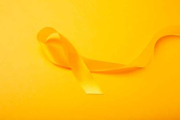 View of yellow ribbon on yellow background