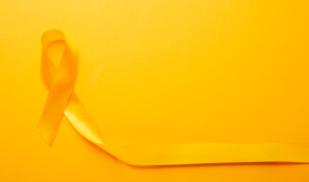 Free Photo view of yellow ribbon on yellow background