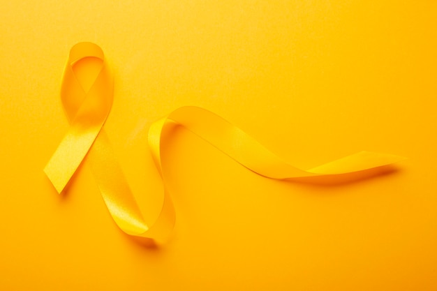 Free photo view of yellow ribbon on yellow background