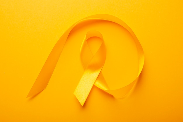 Free photo view of yellow ribbon on yellow background