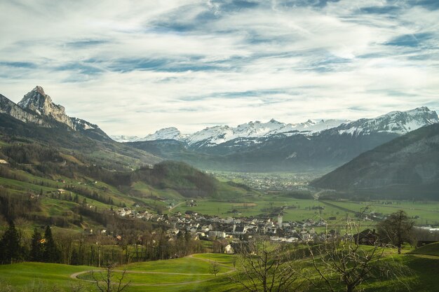 Village in a beautiful valley with snow caped mountains