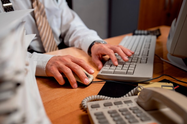 Free photo vintage 90's style office with person working at a desk