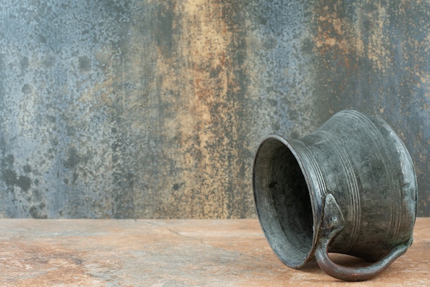 Vintage antique ancient kettle on marble background