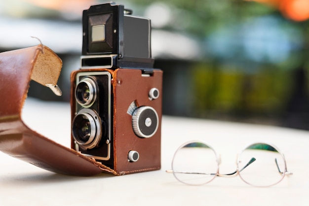 Vintage camera and glasses on the table