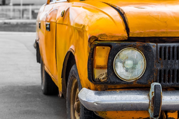 Free photo vintage car yellow. closeup. broken.