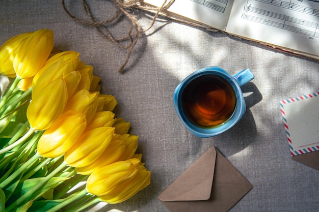 Free Photo vintage composition with a cup of tea tulips and notes flat lay