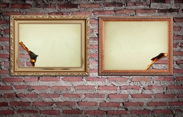 Free photo vintage gold frame with burned on wall background