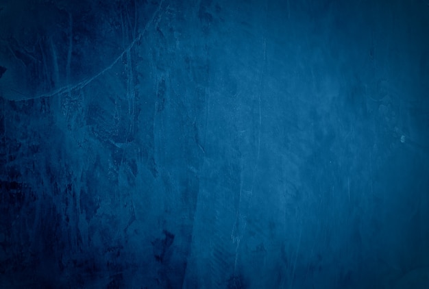 Free photo vintage grunge blue concrete texture studio wall background with vignette.