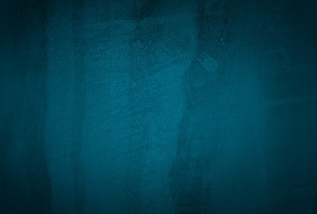 Vintage grunge blue concrete texture studio wall background with vignette.