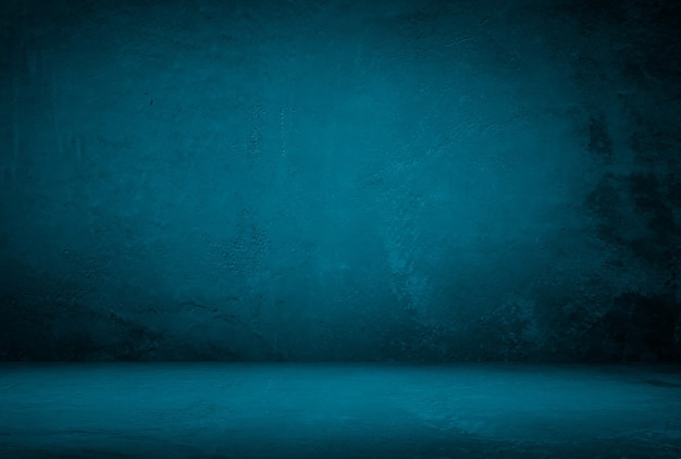 Vintage grunge blue concrete texture studio wall background with vignette.