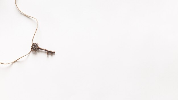 Vintage key hanging on white background