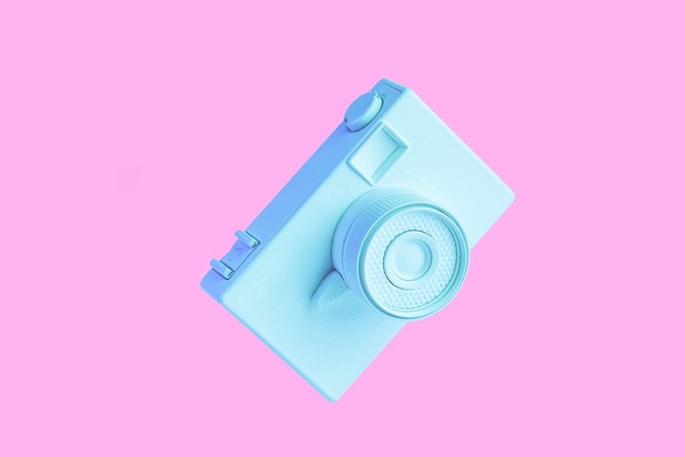 Free photo vintage painted blue camera against pink background