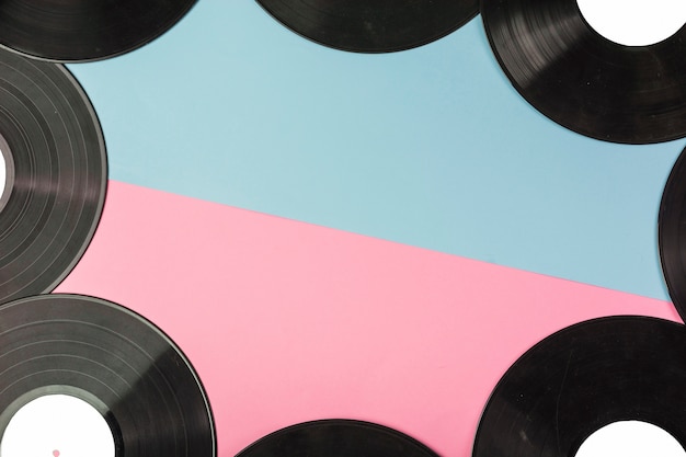 Vinyl records border on dual blue and pink background