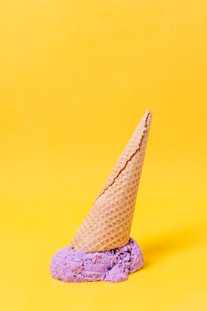 Violet ice cream and cone on the floor